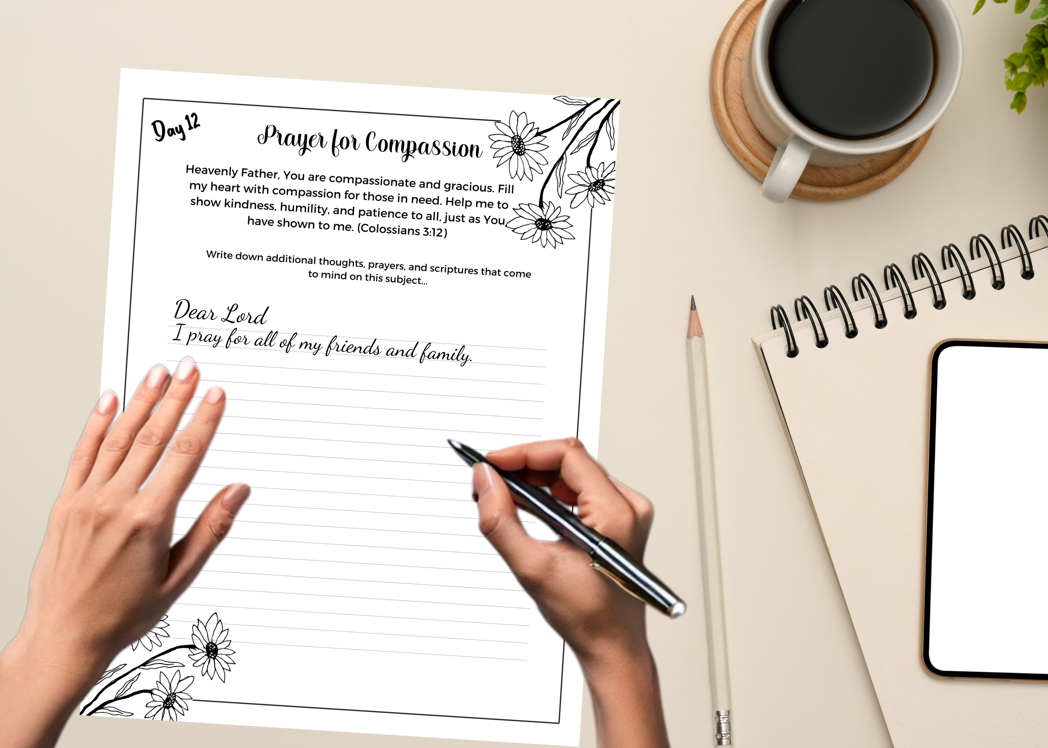 Hands holding printed pages of the Daily Prayer Journal, ready to start a devotional session.